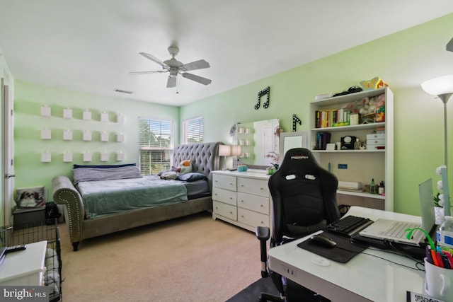 bedroom featuring ceiling fan and light carpet