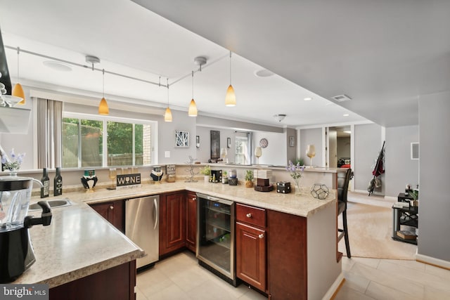 kitchen with beverage cooler, fridge, a breakfast bar area, and hanging light fixtures