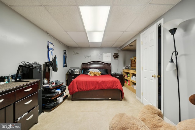 carpeted bedroom featuring a paneled ceiling