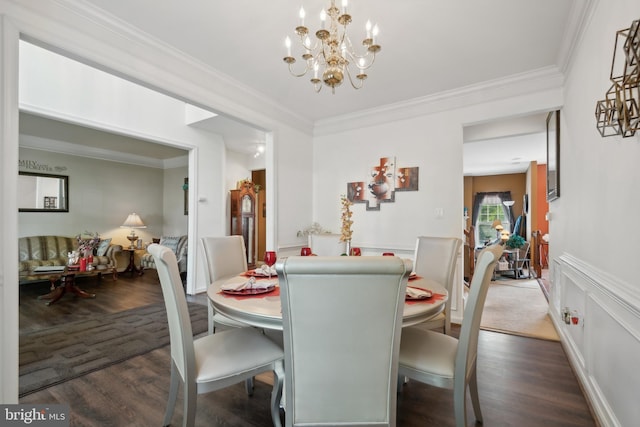 dining space with dark wood-type flooring, an inviting chandelier, and crown molding