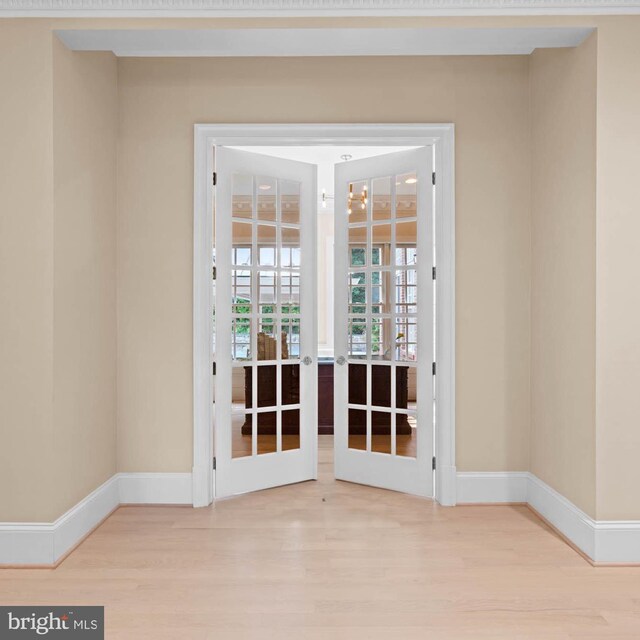 unfurnished room featuring light wood-type flooring and french doors