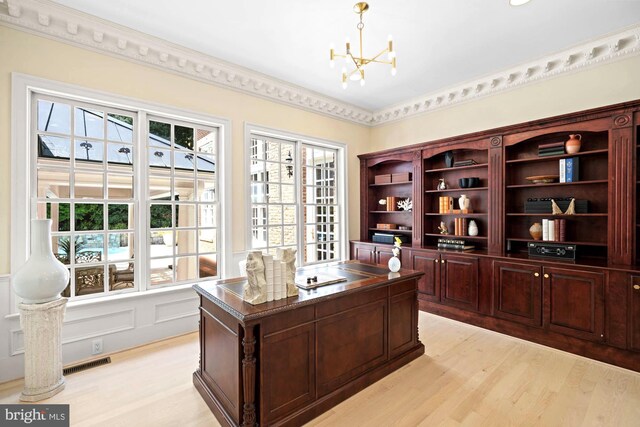 office space with an inviting chandelier and light hardwood / wood-style floors