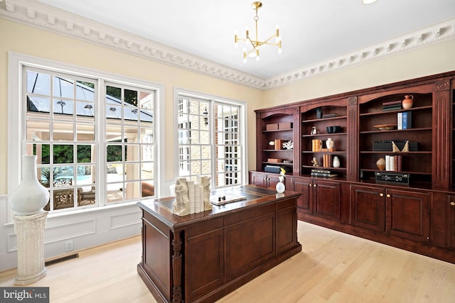 home office featuring visible vents, crown molding, light wood-type flooring, a chandelier, and a decorative wall