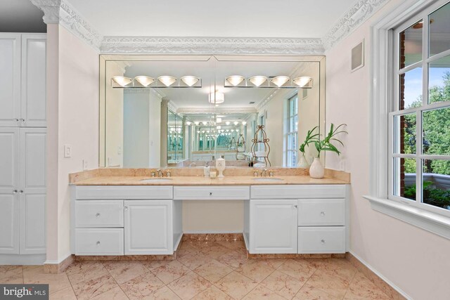 bathroom featuring ornamental molding and vanity