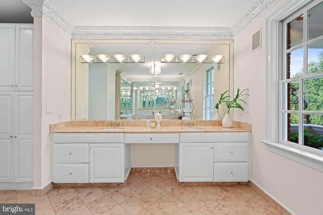 bathroom with double vanity, a sink, and baseboards