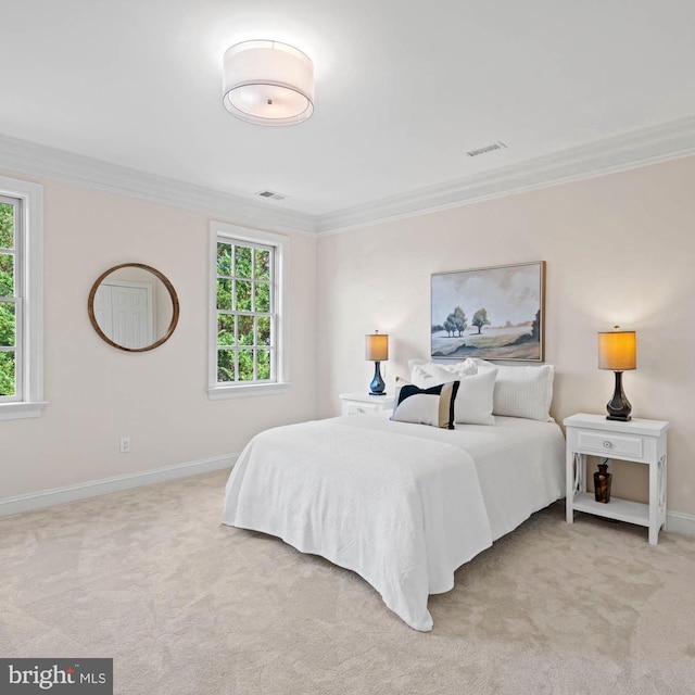 bedroom with ornamental molding, light carpet, visible vents, and baseboards