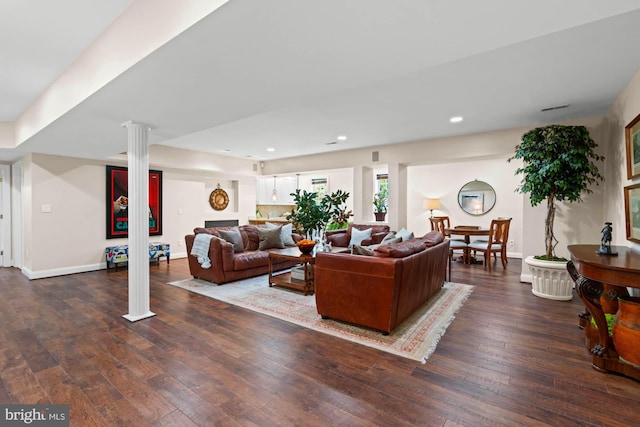 living area featuring hardwood / wood-style flooring, decorative columns, baseboards, and recessed lighting