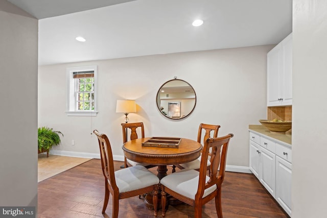 dining area with dark wood-style floors, baseboards, and recessed lighting