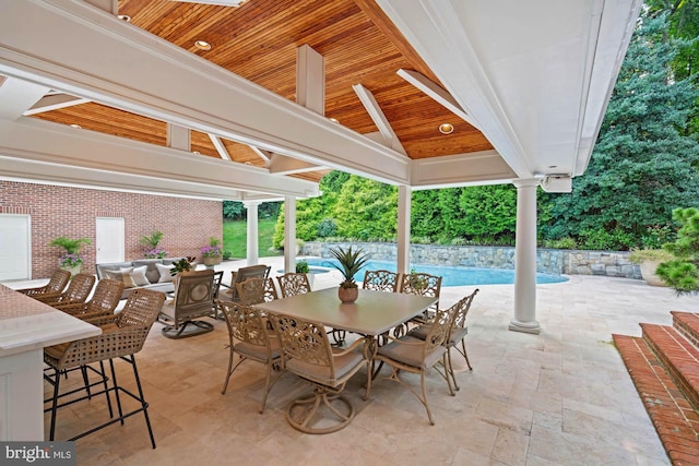 view of patio with a gazebo, an outdoor pool, and outdoor dining space