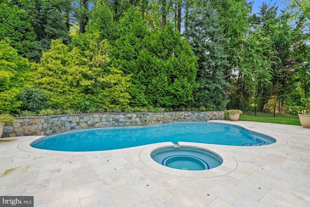 outdoor pool with an in ground hot tub and a patio