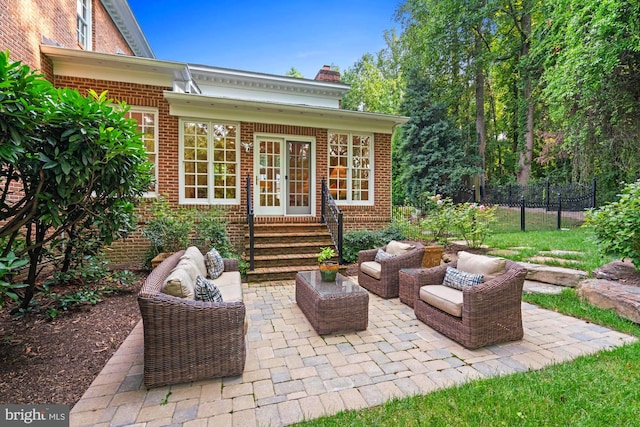 view of patio featuring entry steps, french doors, outdoor lounge area, and fence