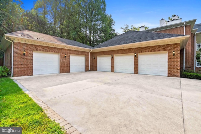 garage featuring concrete driveway