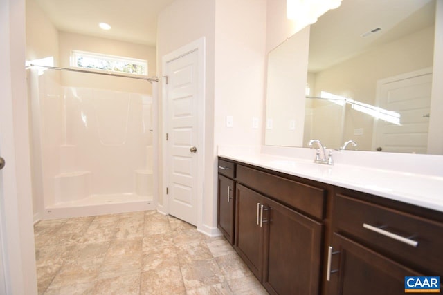 bathroom featuring vanity and a shower