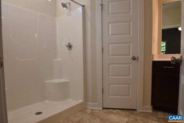 bathroom featuring vanity and a shower