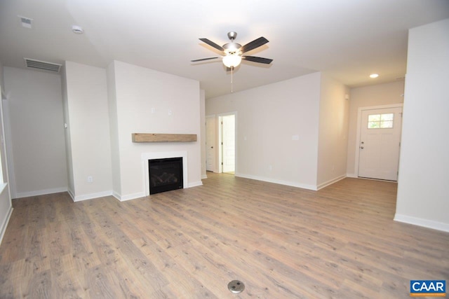 unfurnished living room featuring ceiling fan and light wood-type flooring