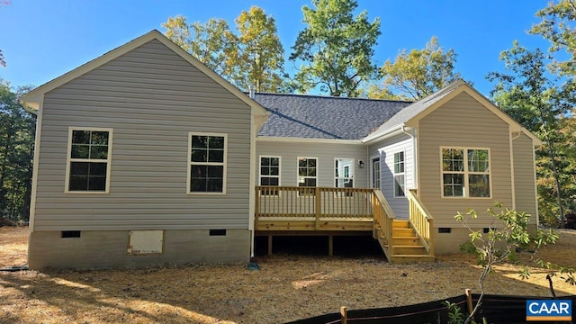 rear view of property featuring a wooden deck