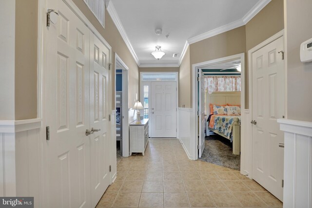 kitchen with appliances with stainless steel finishes, light tile patterned floors, a center island with sink, and hanging light fixtures