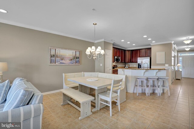 dining room featuring ceiling fan with notable chandelier, ornamental molding, and light tile patterned flooring