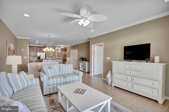 dining area with crown molding, light tile patterned floors, and a chandelier