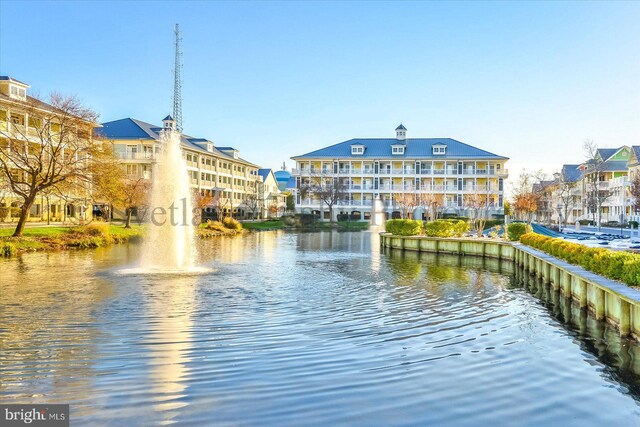 surrounding community featuring a water view and a lawn