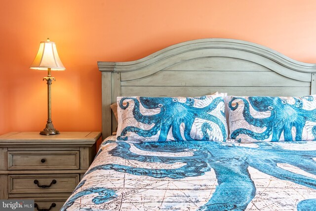 carpeted bedroom featuring ceiling fan and crown molding