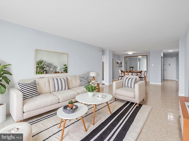 living room featuring light tile patterned floors and baseboards