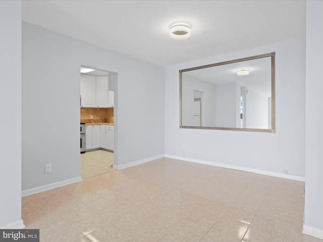 interior space featuring light tile patterned floors and baseboards