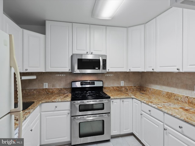 kitchen with stainless steel appliances and white cabinetry