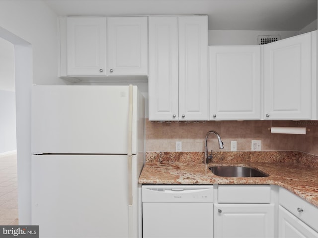 kitchen with white appliances and white cabinets