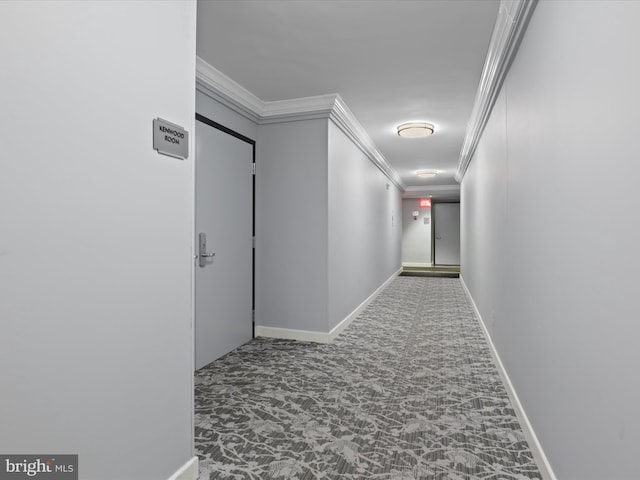 hallway with ornamental molding, carpet, and baseboards