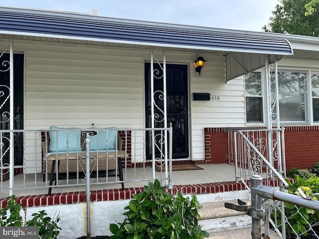 view of exterior entry with a porch