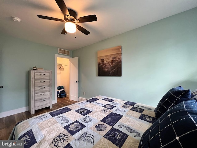 bedroom with ceiling fan, ensuite bath, and wood-type flooring