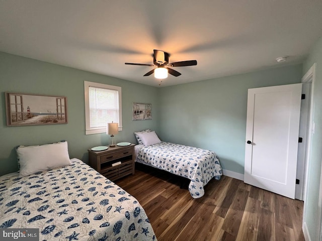 bedroom featuring ceiling fan and dark hardwood / wood-style floors