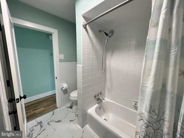 bathroom featuring hardwood / wood-style flooring, shower / bath combo, toilet, and tile walls