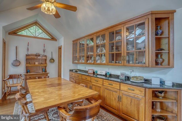 130 Mcfee St, Lewes, DE 19958 - kitchen with open shelves, light wood-style floors, brown cabinetry, ceiling fan, and vaulted ceiling