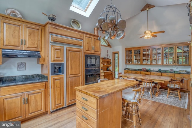 130 Mcfee St, Lewes, DE 19958 - kitchen featuring black appliances, wood counters, a skylight, a ceiling fan, and light wood-style floors