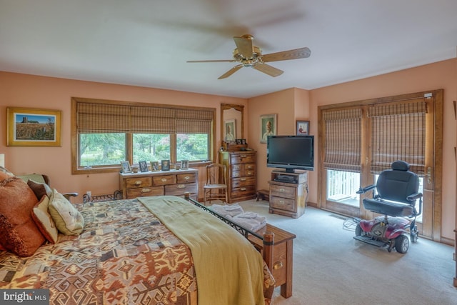 carpeted bedroom featuring access to exterior, ceiling fan, and multiple windows