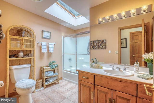 130 Mcfee St, Lewes, DE 19958 - bathroom featuring a skylight, toilet, vanity, tile patterned flooring, and enclosed tub / shower combo