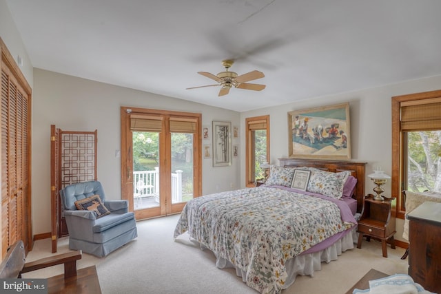 bedroom with access to outside, multiple windows, lofted ceiling, and ceiling fan