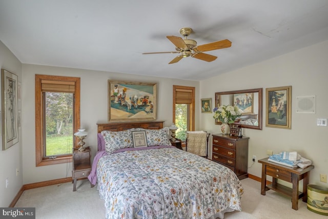 bedroom with ceiling fan, light colored carpet, and lofted ceiling