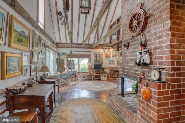 interior space with beamed ceiling and high vaulted ceiling