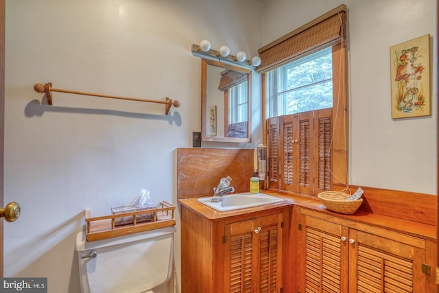 bathroom featuring vanity and toilet