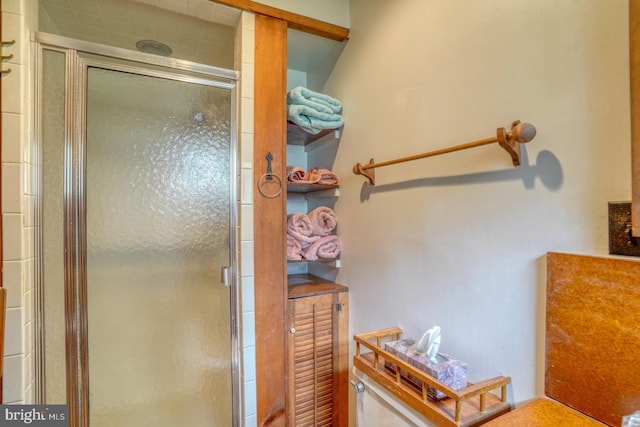 bathroom featuring a shower with shower door