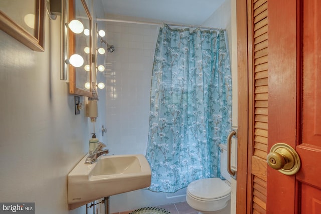 full bathroom with toilet, tile patterned floors, shower / bathtub combination with curtain, and sink