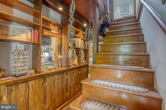 staircase with hardwood / wood-style floors