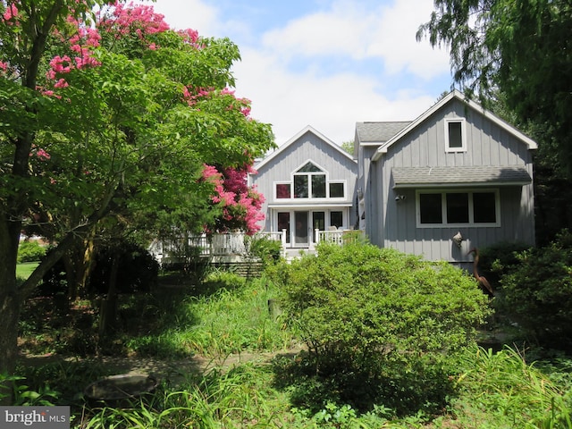 130 Mcfee St, Lewes, DE 19958 - rear view of property featuring a shingled roof and board and batten siding
