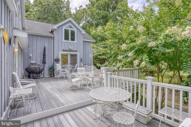 130 Mcfee St, Lewes, DE 19958 - wooden terrace with outdoor dining area, area for grilling, and view of wooded area
