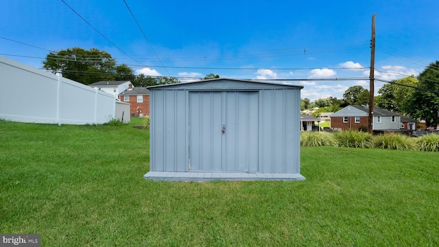 view of outbuilding featuring a yard