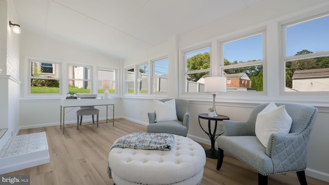 sunroom / solarium with lofted ceiling and a healthy amount of sunlight