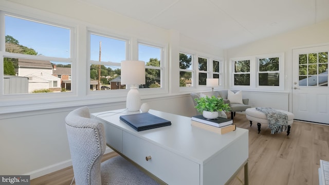 sunroom / solarium with vaulted ceiling and a healthy amount of sunlight